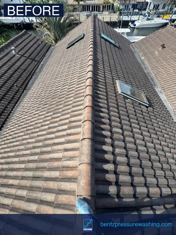 Tile roof cleaning before Fort Lauderdale waterfront home — heavy algae and discoloration